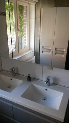 a bathroom with a white sink and a mirror at 't Hagerhuys in Maaseik