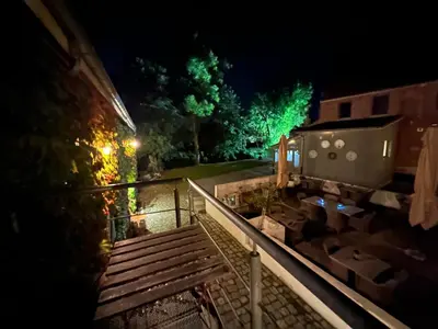a set of stairs leading up to a building at night at De Verborgen Parel B&B in Borgloon