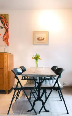 a table and chairs in a room with a painting at Lyves in Liège