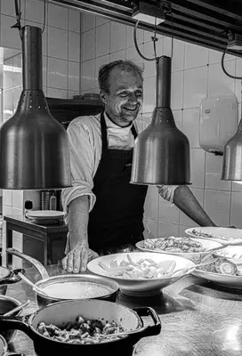 a man standing in a kitchen preparing food at PRET A GOUTER bistro bar bed in Heusden - Zolder