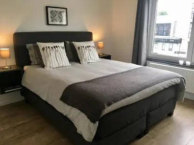 a bedroom with a large bed and a window at L'Inizio Suite in Herve