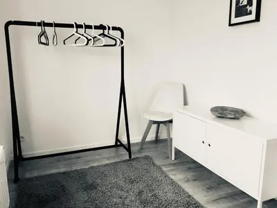 a white room with a black rack of glasses at L'Inizio Suite in Herve