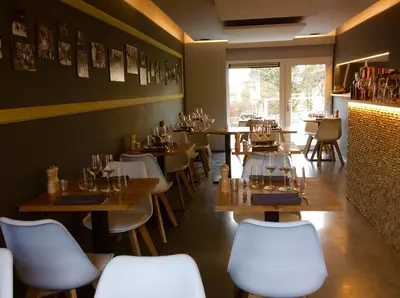 a restaurant with wooden tables and chairs in a room at L'Inizio Suite in Herve
