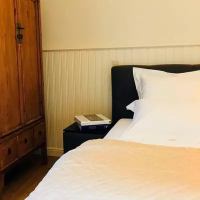 a bedroom with a bed and a book on a night stand at Kirisavan Bed&Breakfast in Borgloon