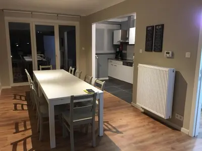 a kitchen and dining room with a table and chairs at Hollandia City House in Hasselt