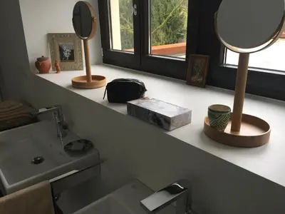 a bathroom with a sink and a mirror on a shelf at fermette in Lontzen