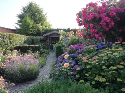 a garden filled with colorful flowers and plants at La Rose in Overpelt