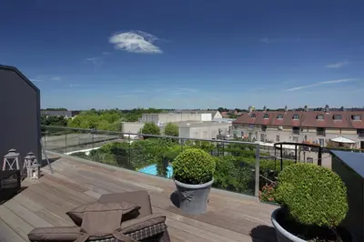 a balcony with a view of a pool at Tuinhotel in Lommel