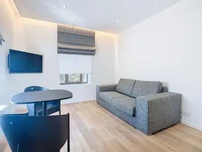 a living room with a couch and a table at Les Begards Espace 9 in Chaudfontaine