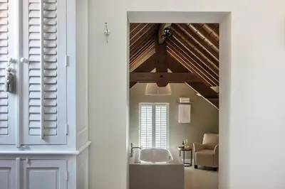 a bathroom with a sink in a room with a ceiling at Villa Copis in Borgloon