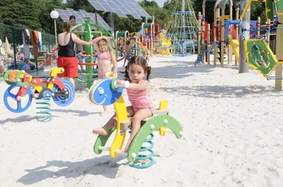 two little girls playing on a playground at Vakantiepark Wilhelm Tell Vakantieappartement in Oudsbergen