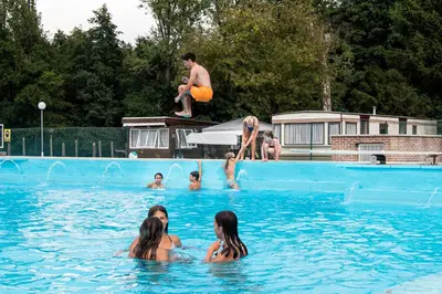a group of people in a swimming pool at Vakantiepark Wilhelm Tell Vakantieappartement in Oudsbergen