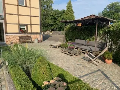 a garden with a couch and a gazebo at 'tMaelhof in Voeren