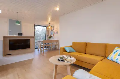 a living room with a couch and a table at Center Parcs Vossemeren in Lommel