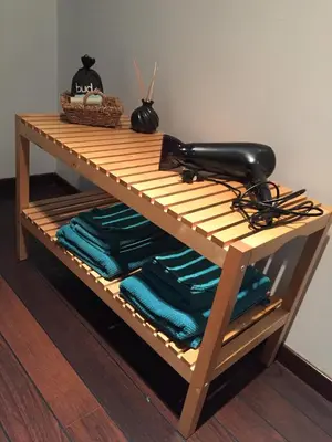 a shelf with towels and a hair dryer on it at Hasselt City Garden Duplex in Hasselt