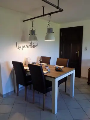 a dining room with a table and chairs at (La parenthese) in Hombourg