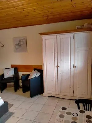 a living room with a cabinet and a couch at gasthof lederhose in Diepenbeek