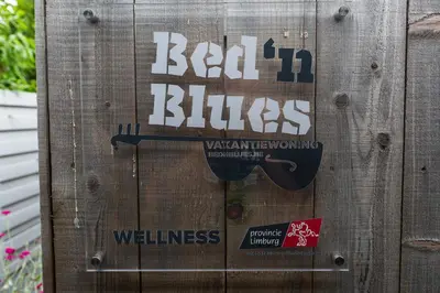 a wooden door with a sign on it at Bed 'n Blues **** in Halen
