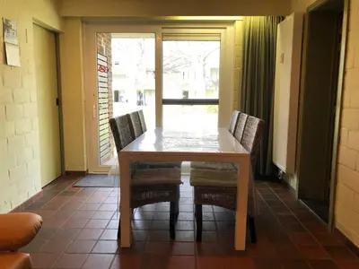 a dining room table with two chairs and a window at Ceder 9 Hengelhoef in Houthalen-Helchteren