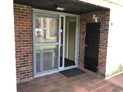 an entryway to a brick house with a sliding glass door at Ceder 9 Hengelhoef in Houthalen-Helchteren
