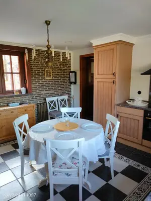 a kitchen with a table and chairs in a room at De Stille Weier in Genk