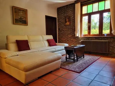 a living room with a couch and a table at De Stille Weier in Genk