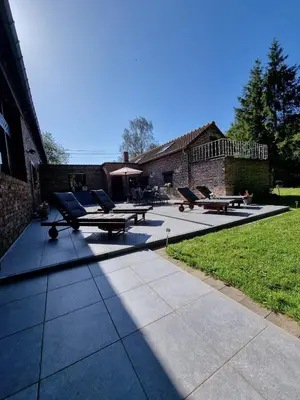 a group of picnic tables and chairs on a patio at De Stille Weier in Genk