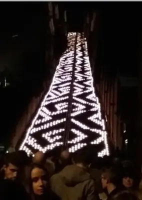 a group of people walking down a street with lights at Au 194 in Liège