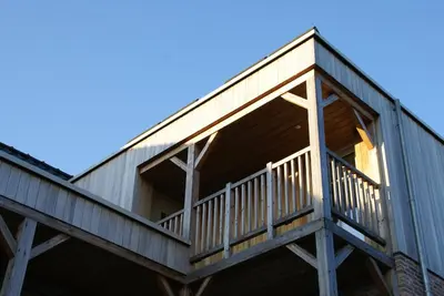 a deck on a house with the sky in the background at B&B Sasput in Hasselt