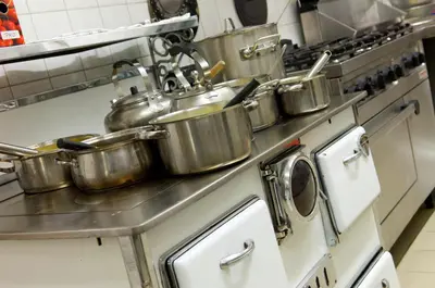a group of pots on a stove in a kitchen at Hotel Restaurant Tychon AG in Eynatten