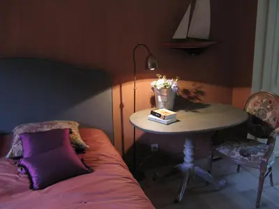 a room with a table and a table with a bed at De Epicurist in Hasselt