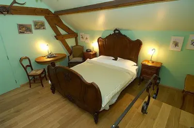 a bedroom with a large wooden bed in a room at Het Pachthof in Borlo