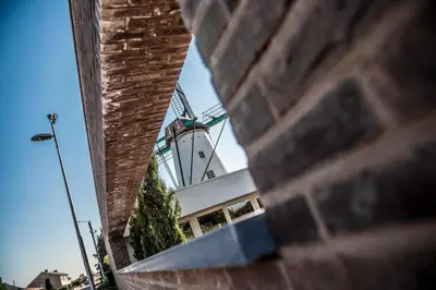 a view of a building through a brick wall at Hotel AL Mulino in Maasmechelen