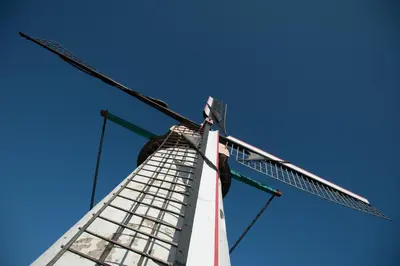 a windmill against a blue sky at Hotel AL Mulino in Maasmechelen