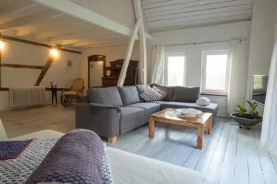 a living room with a couch and a table at Bellevue Maison de Greunebennet in Plombières