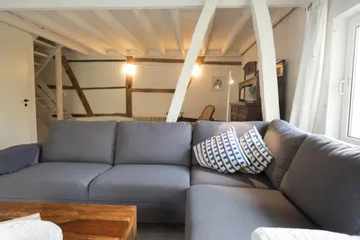 a living room with a blue couch and a table at Bellevue Maison de Greunebennet in Plombières