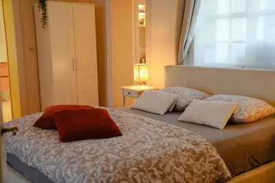 a bedroom with a bed with two pillows and a window at Gastenkamers In de Bleick in Rekem