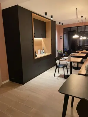 a dining room with tables and chairs and a counter at B&B Maris Logies in Hasselt