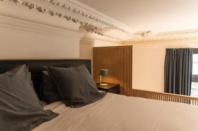 a bedroom with a bed and a window at Appartement Guillemins Station Terrace in Liège