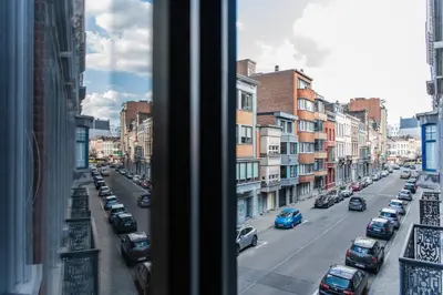 a view from a window of a city street with cars at Appartement Guillemins Station Terrace in Liège