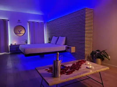 a bedroom with a bed and a table in a room at La bulle D'orée in Chaudfontaine