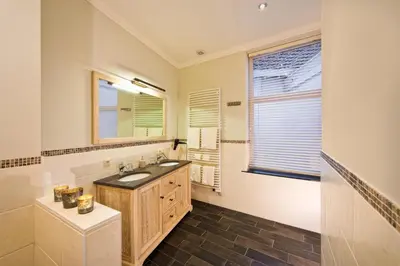 a bathroom with a sink and a mirror at Boutique Hotel Caelus VII in Tongeren