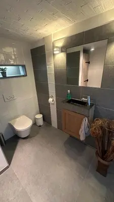 a bathroom with a toilet and a sink and a mirror at Bed & Bets! in Geetbets