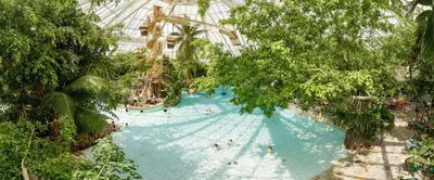 an indoor water park with people on a roller coaster at Hotel De Vossemeren by Center Parcs in Lommel