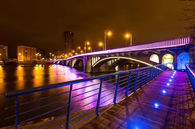 a bridge over a river at night with purple lights at Studio des princes in Liège