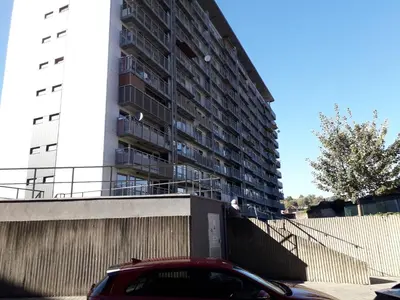 a red car parked in front of a building at Leonard room in Liège
