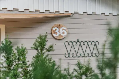 a house with a number on the side of it at Chalet 2Relax in Zutendaal