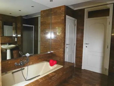 a bathroom with a tub with a red heart on it at Suite Horatio in Heusden - Zolder