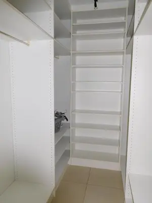 a walk in closet with white shelves at Suite Horatio in Heusden - Zolder