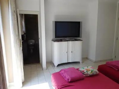 a living room with a flat screen tv and a couch at Suite Horatio in Heusden - Zolder